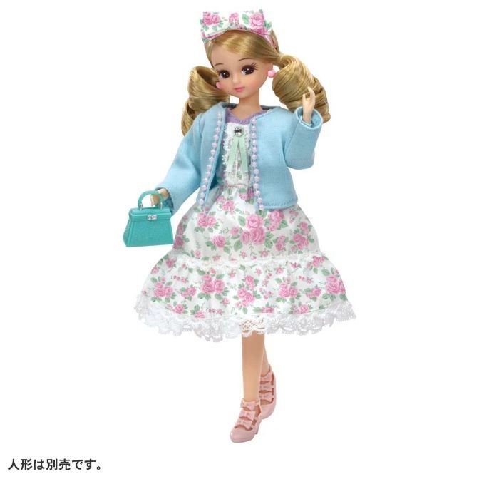 Licca doll in floral dress, blue cardigan, matching headband and purse, and pink shoes.