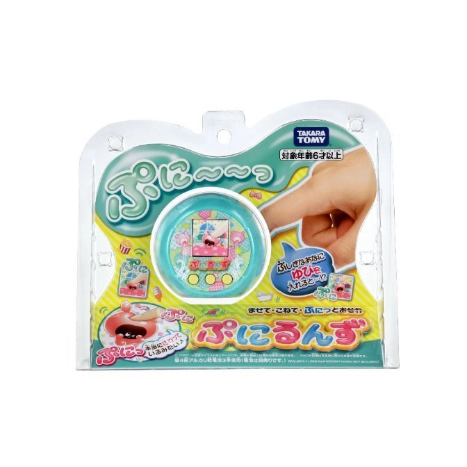  Takara Tomy Punirunes virtual pet toy in packaging. Finger interacting with screen.