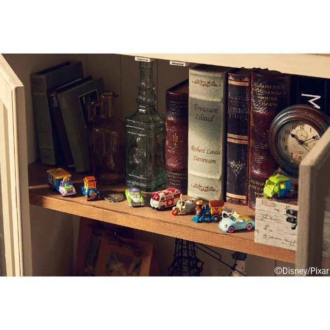  Shelf with toy cars, books, and bottles. Features a clock and a treasure chest.