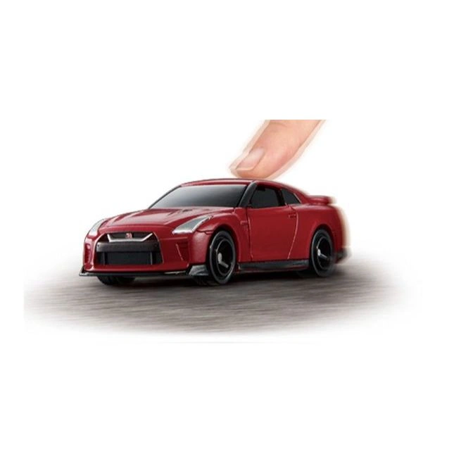 Red toy Nissan GT-R with finger on top, suggesting play or control.