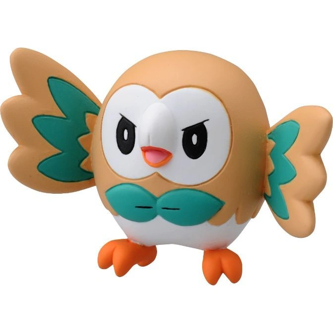 Rowlet toy figure with tan body, white face, green bow tie and wing accents, and orange feet.