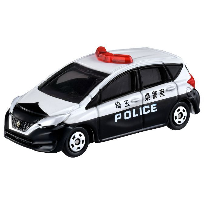 Toy Japanese police car with red light bar, black and white paint, and 'POLICE' on the side.