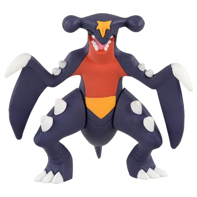  Garchomp toy figure with dark blue body, red chest, yellow star on head, and white claws.