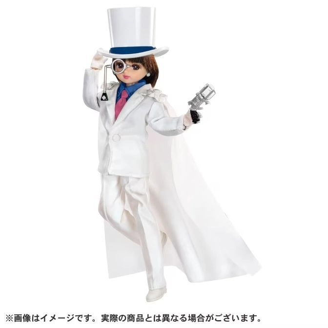 Doll of a person in a white suit, cape, and top hat, holding a toy gun and monocle.