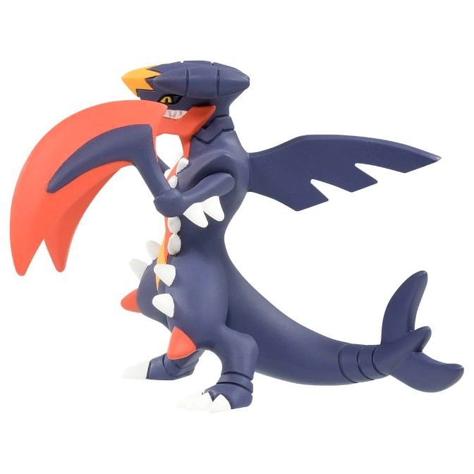  Garchomp toy figure with orange and navy blue coloring, standing in a dynamic pose.