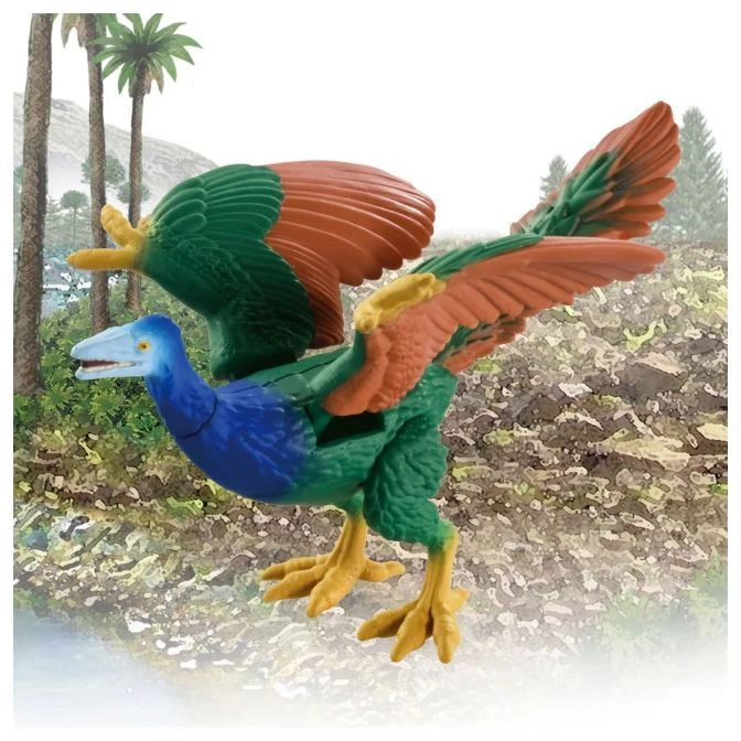  Colourful toy Archaeopteryx with green, blue, and orange plumage standing in a prehistoric landscape.