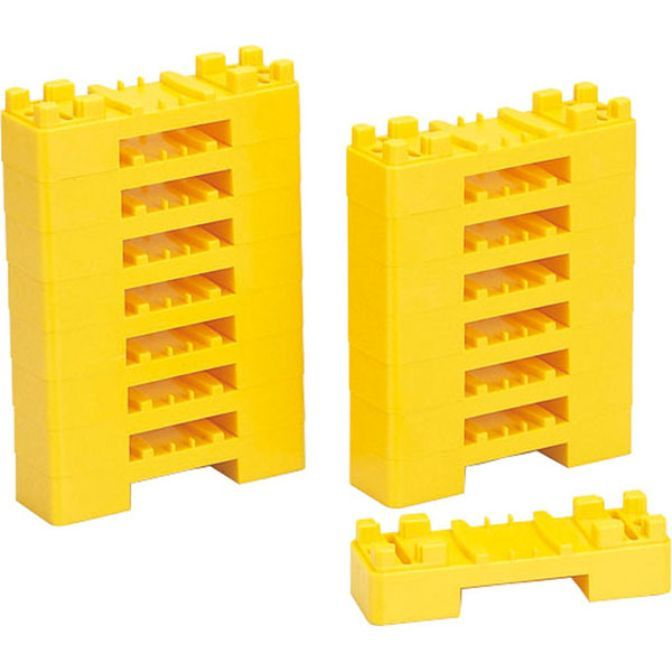 Two stacks of yellow plastic building blocks, with one block lying separately.