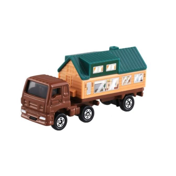 Toy truck carrying a house with a green roof.