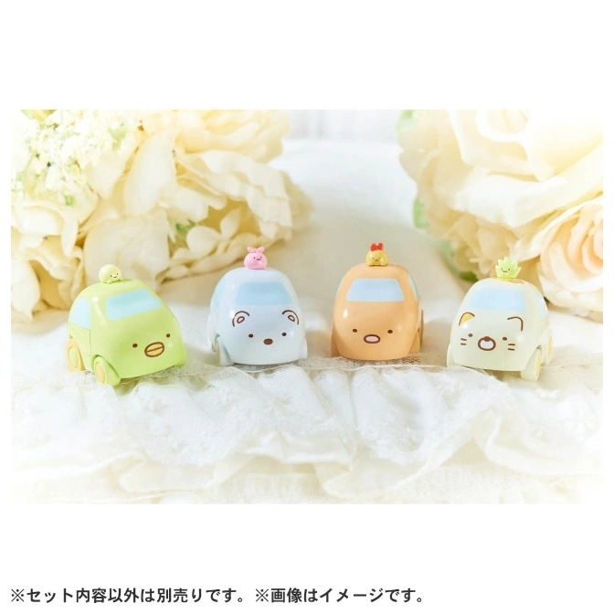  Four Sumikko Gurashi character cars: green, blue, orange, and white, on a lace surface.