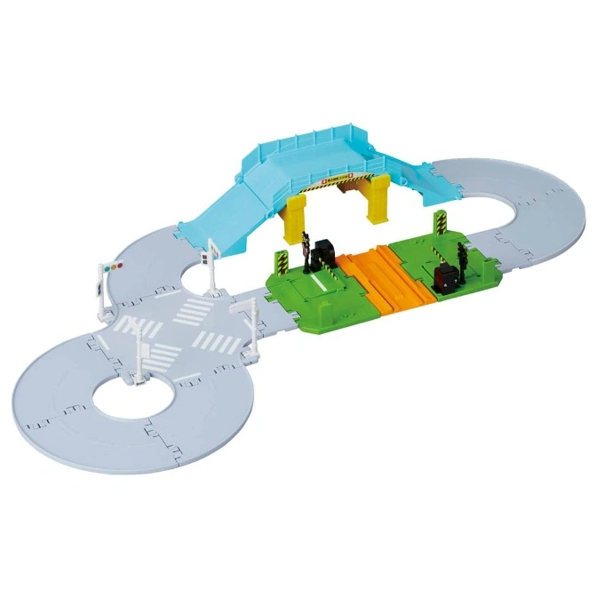 Toy car track with bridge, railroad crossing, and intersection. A miniature playset for kids.
