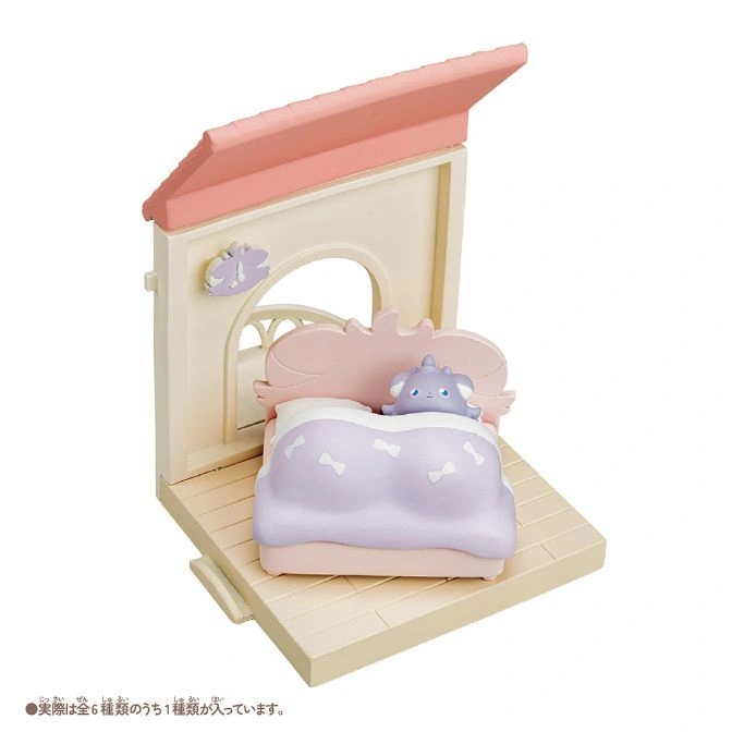  Toy house with a bed and a purple creature under the covers.