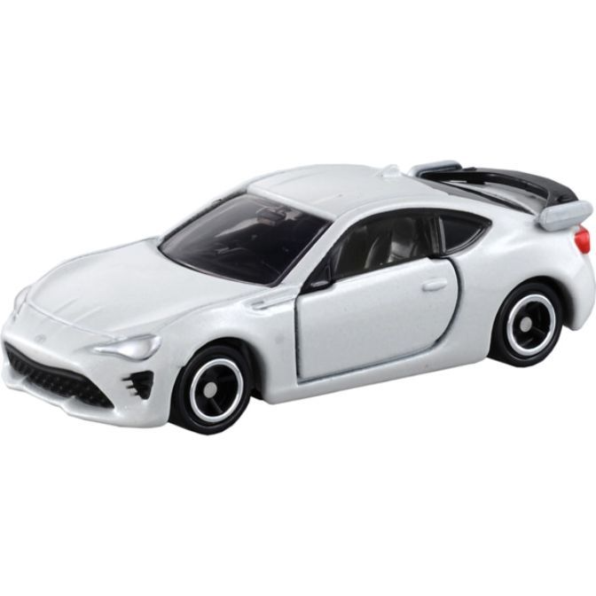 White toy car with black wheels and spoiler.