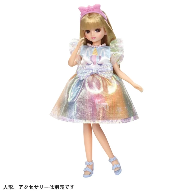  Doll with blonde hair wearing a unicorn dress, headband, and blue sandals.