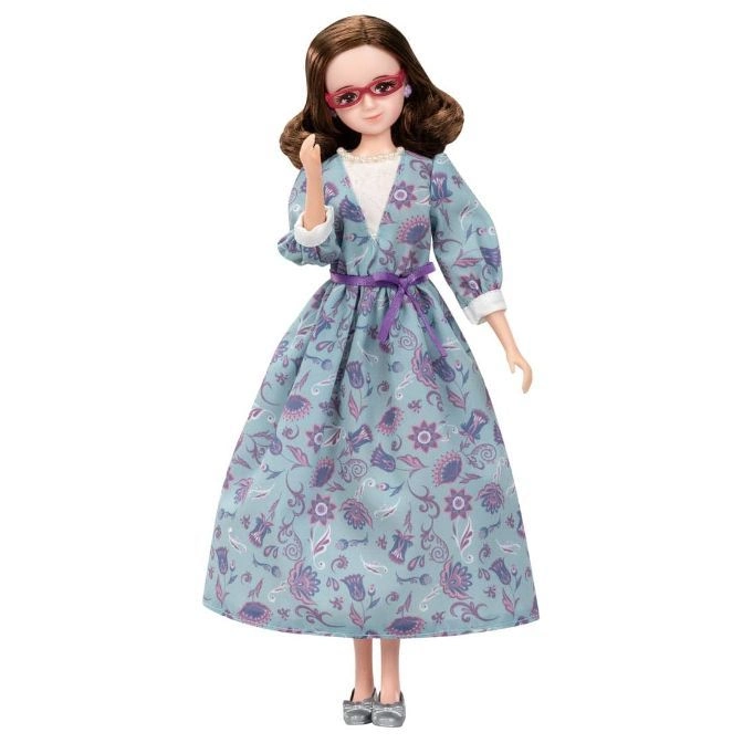 Doll in a floral dress, glasses, and silver shoes.