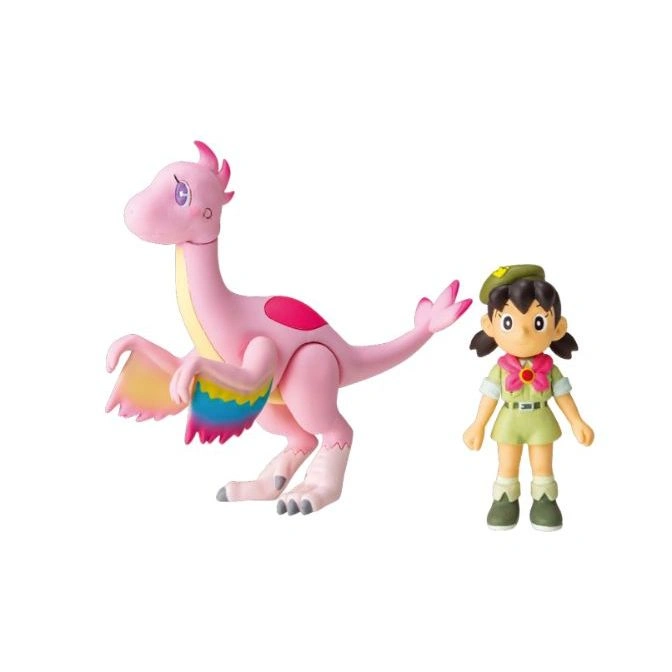 Pink dinosaur toy with rainbow wings next to a girl scout action figure.