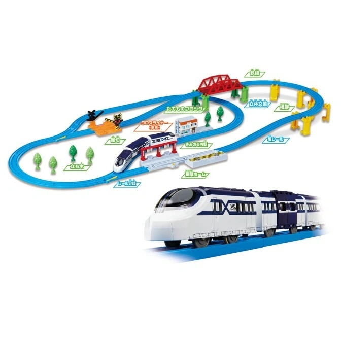 Toy train set with blue tracks, a white and blue train, a bridge, and buildings.