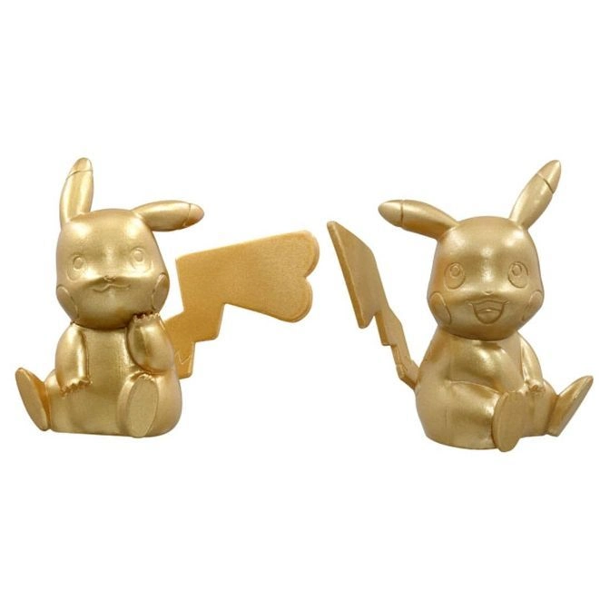 Two golden Pikachu figures sitting with lightning bolt tails.
