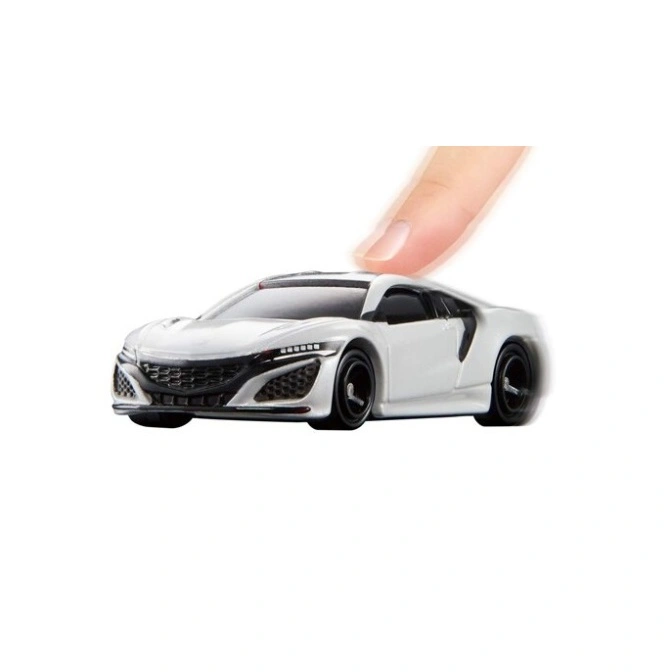 White toy Honda NSX with a finger pressing down on the roof, suggesting play or interaction.