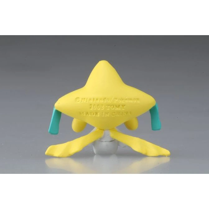  Yellow Jirachi toy figure with teal tags and a white base. Text on the bottom reads "Nintendo/Pokemon 2003 TOMY MADE IN CHINA."