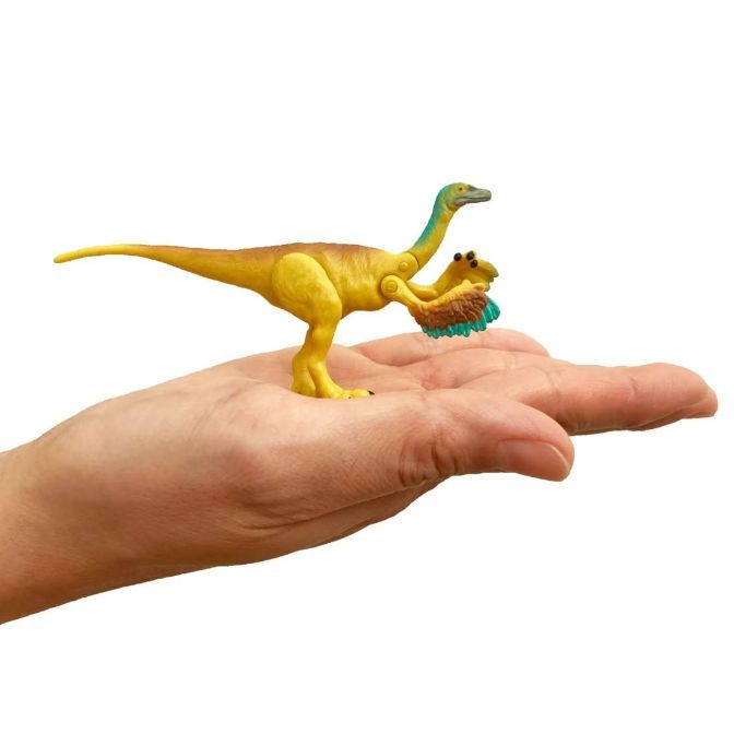  Yellow dinosaur toy with blue neck and feathered arms on a hand.