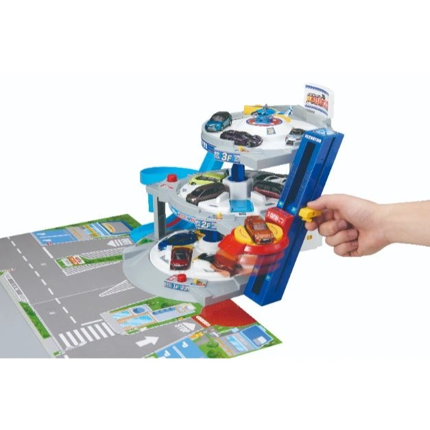  Toy car park with cars, elevator, and city playmat. Hand operating elevator.