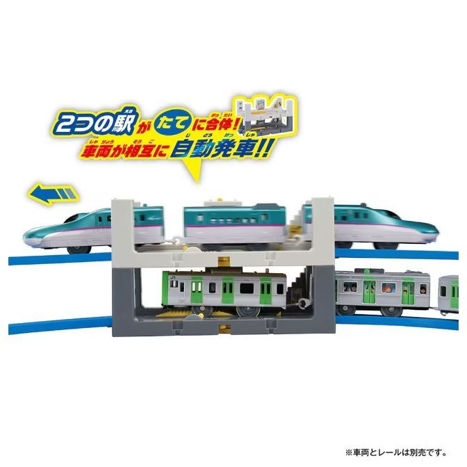  A toy train set with two levels of trains, featuring a bullet train on the top level and a commuter train on the bottom level.