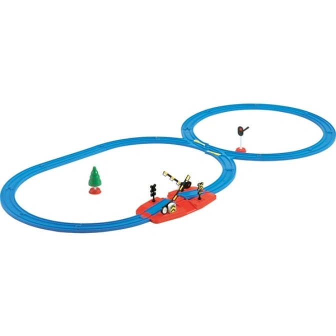 Toy train set with blue tracks, a red crossing gate, a signal, and a green tree.