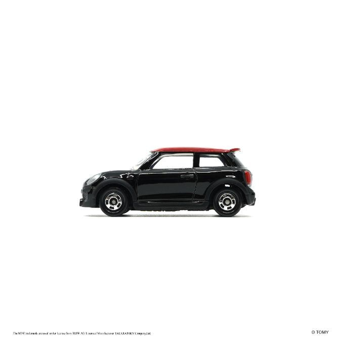 Black toy Mini Cooper with a red roof. Diecast model car.