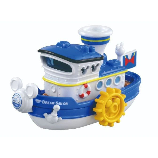 Blue and white toy steamboat with paddle wheel, life preserver, and "Dream Sailor" text.