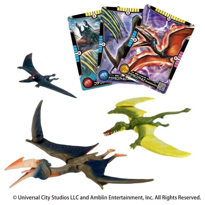 Pterodactyl toys and cards: one brown, one green, and one dark grey.
