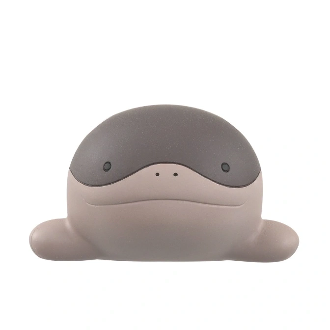 Gray and beige, dome-shaped toy with small eyes and dots for a nose.