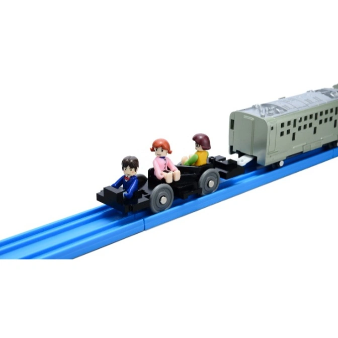  Toy train with three figures riding in an open car, attached to a silver train car on a blue track.