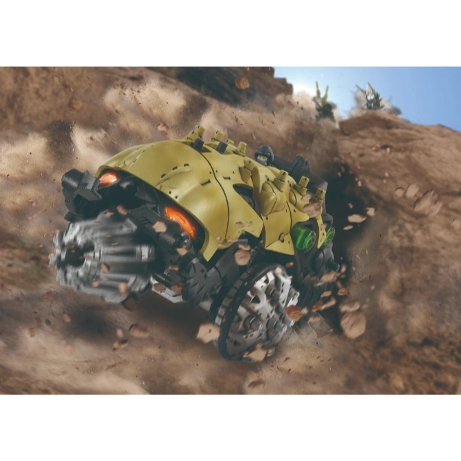  Yellow toy drill vehicle driving through a rocky landscape, kicking up debris.