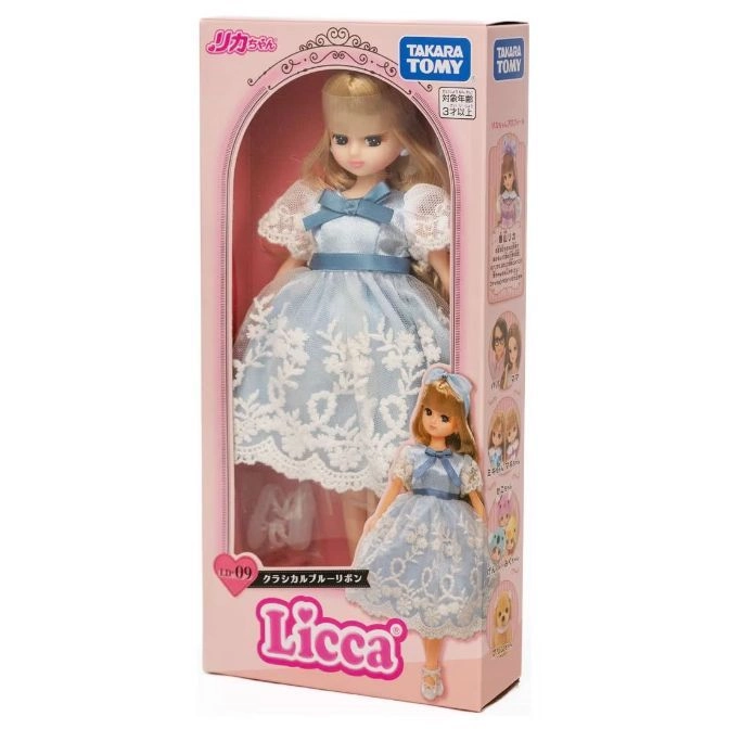  Licca doll in a blue dress with lace, packaged in a pink box with the brand name.