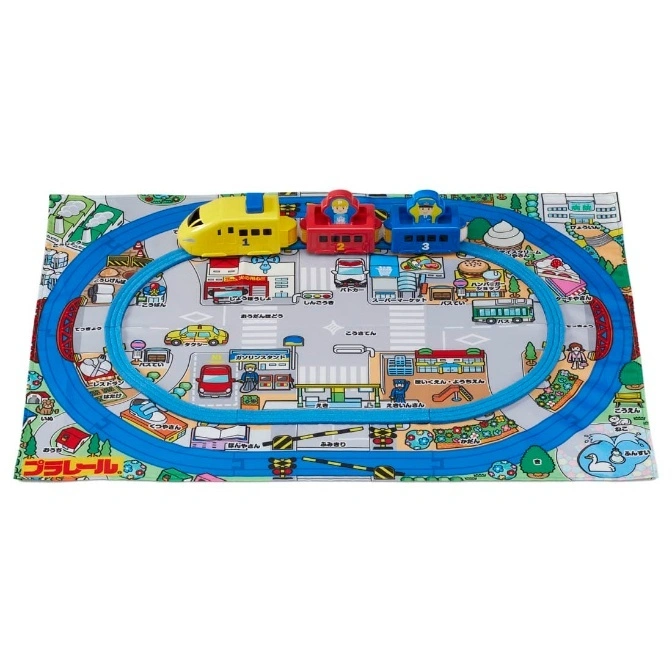  Toy train on a playmat with a town design. The train has yellow, red, and blue cars.