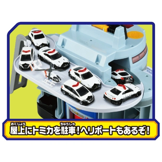  Toy police station with cars and a helicopter parked on the roof helipad.