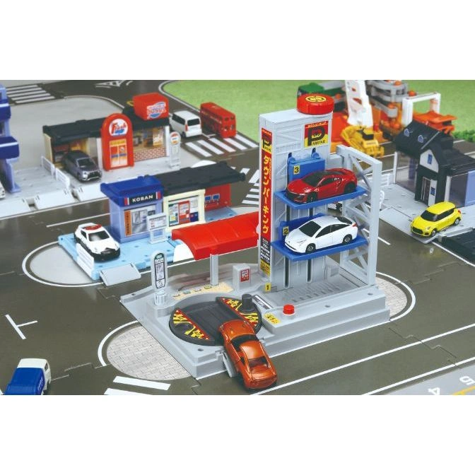  Toy car playset with parking garage, police station, shops, and toy cars.
