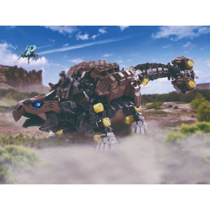  Brown Zoids toy with glowing yellow accents and blue eye, walking through a dusty landscape.
