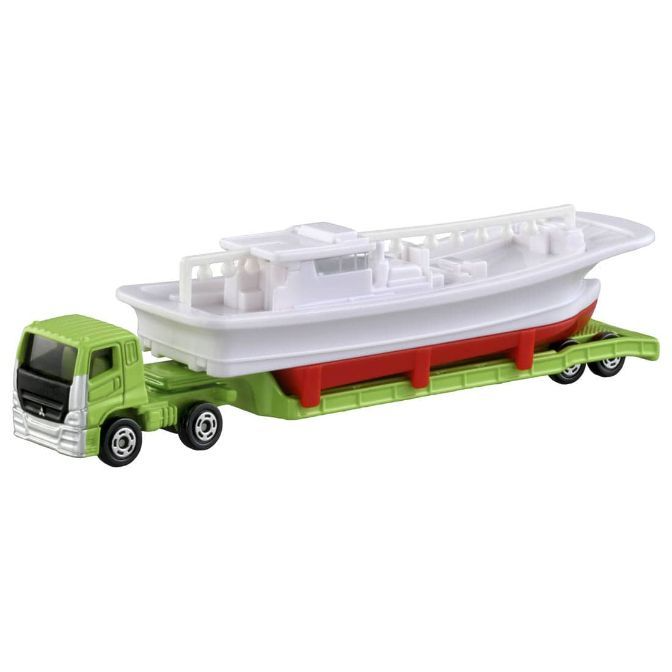 Toy truck carrying a boat. The truck is green and the boat is white with a red hull.