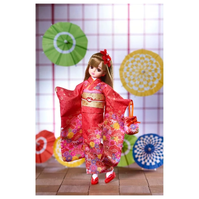  Licca doll in red kimono with floral patterns, holding a matching purse, against a backdrop of colorful paper umbrellas.