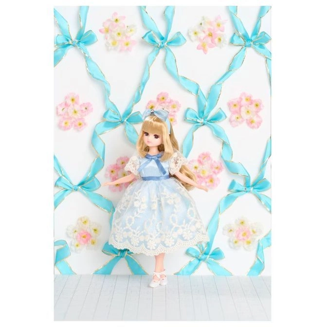 Doll in a blue dress with ribbons and flowers on the background.