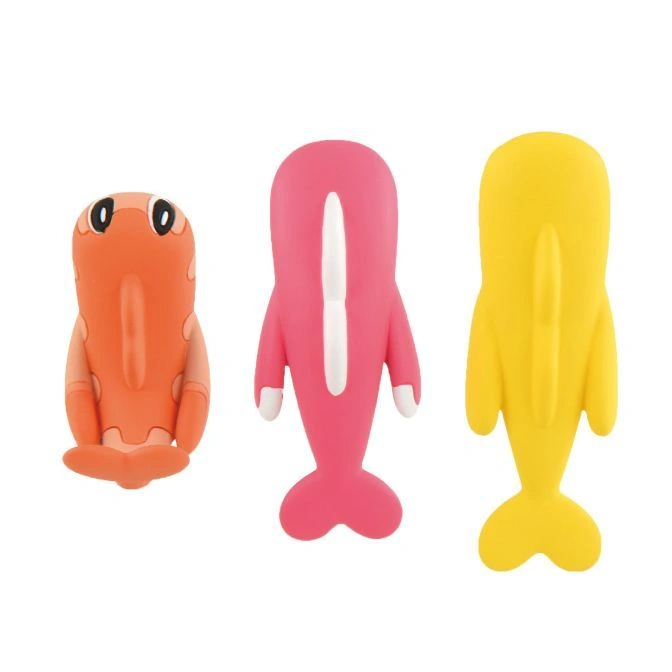  Three colorful toy erasers: an orange creature, a pink dolphin, and a yellow dolphin.