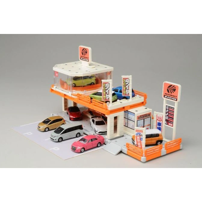 Autobacs toy car park with miniature cars, signs, and multi-level parking, simulating a real-world auto service center.