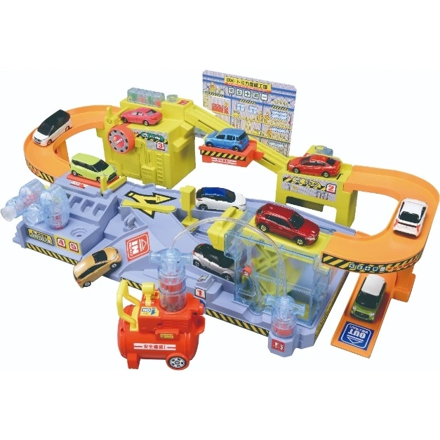 Tomica DX car service station toy with toy cars on ramps, lifts, and repair bays.