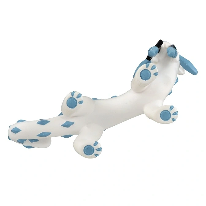  White dragon toy with blue spots and paw prints lying on its back.