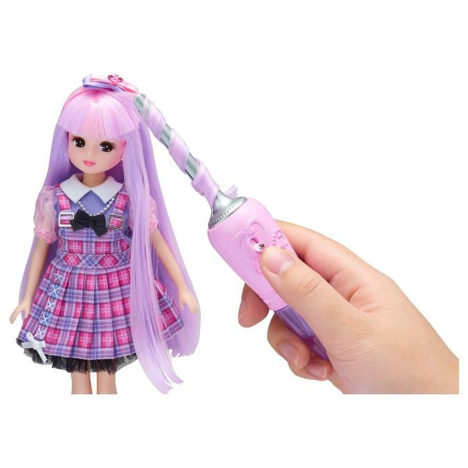  Doll with pink hair having her hair styled with a pink and silver styling tool.