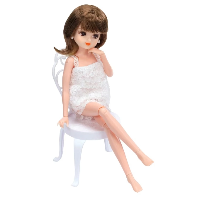  Licca-chan doll in white dress sitting on a white chair.