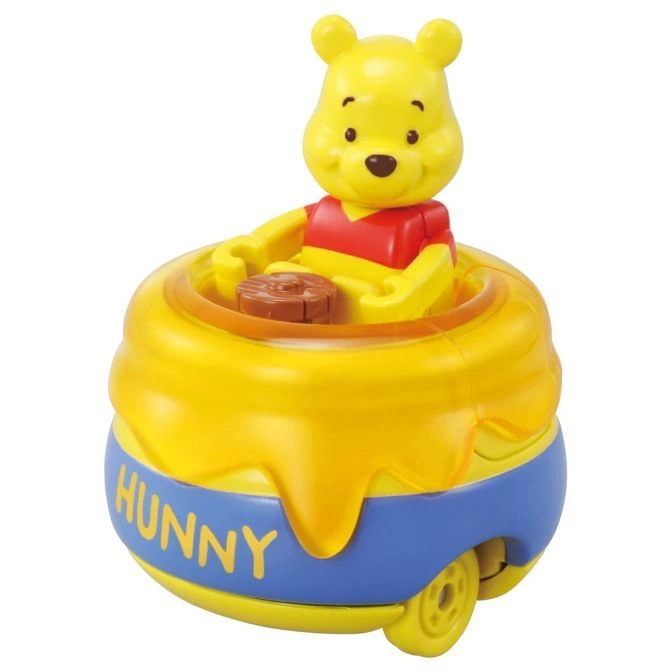 Winnie the Pooh toy car in a honey pot with 'Hunny' written on it.