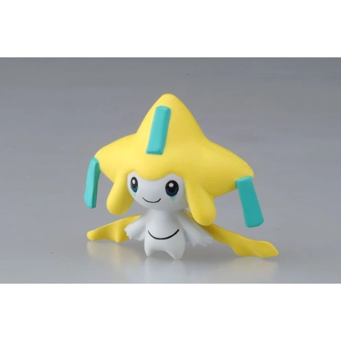 Jirachi toy figure with yellow star-shaped head and teal accents, smiling.