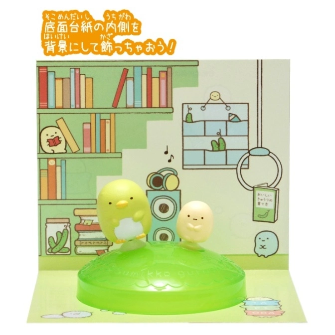  Sumikko Gurashi toy set with figures on a green base, against a backdrop of a room interior.